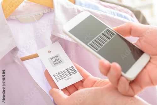 Woman scanning barcode with mobile phone