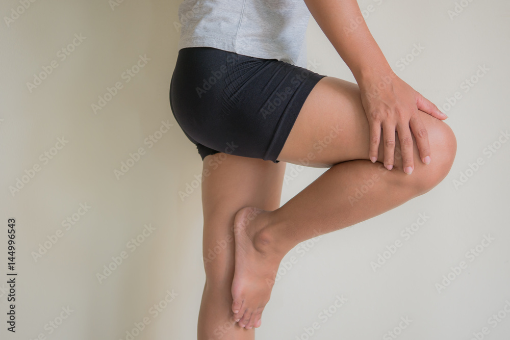 Woman injured leg with calf feeling pain .