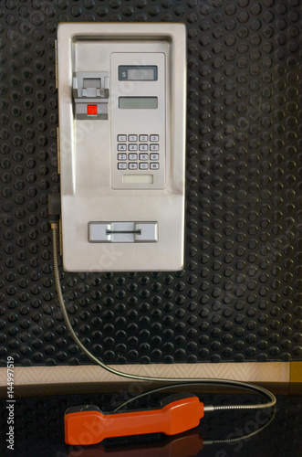 The pay phone on the wall inside the building.