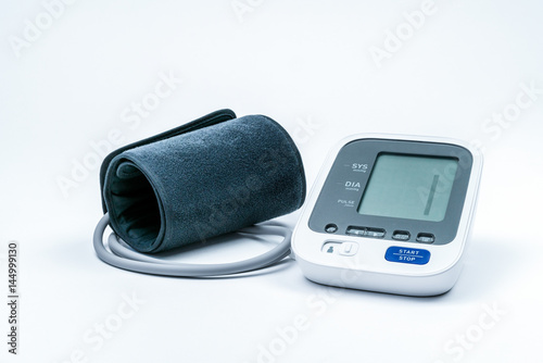 Automatic portable blood pressure machine with arm cuff isolated on white with copy space, studio shot. 