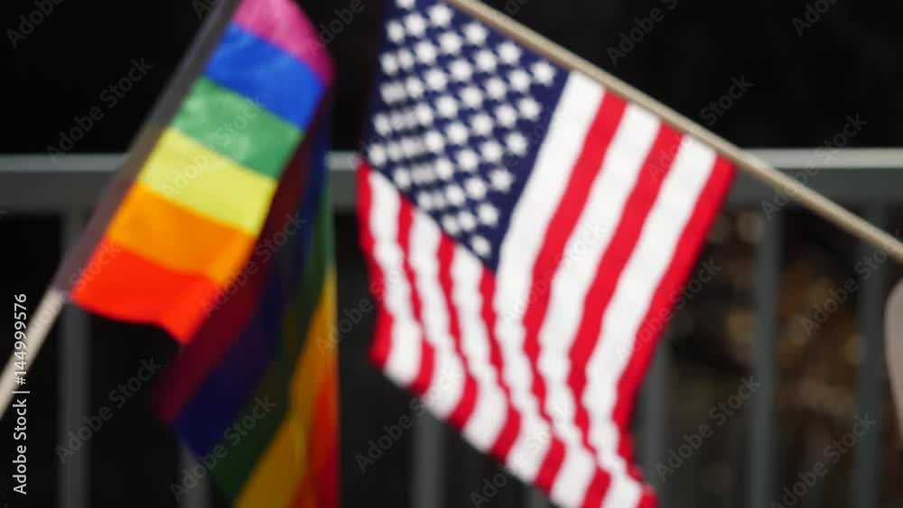 Rainbow gay pride symbol floating outside with an american flag.