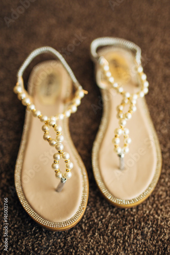 Wedding shoes on the pool background. Wedding in the tropics concept
