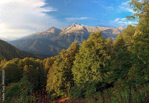 Beautiful scenic summer landscape of Caucasus mountains with blue sky and Chugush Peak on background