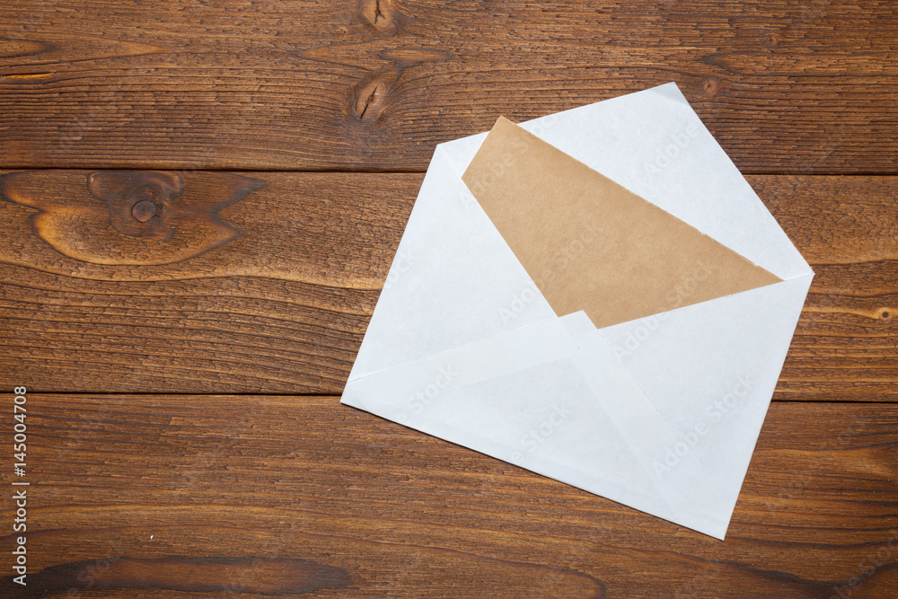 Blank paper, envelope on wooden table Blank paper, envelope on wooden table