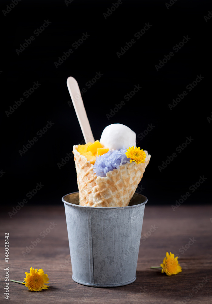 Ice cream cones with sticky rice in a metal basket on wooden, selective focus