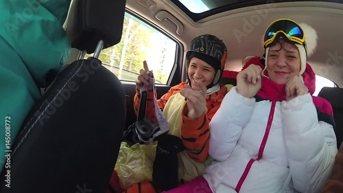 girl skier having fun with the music in the car on the trip