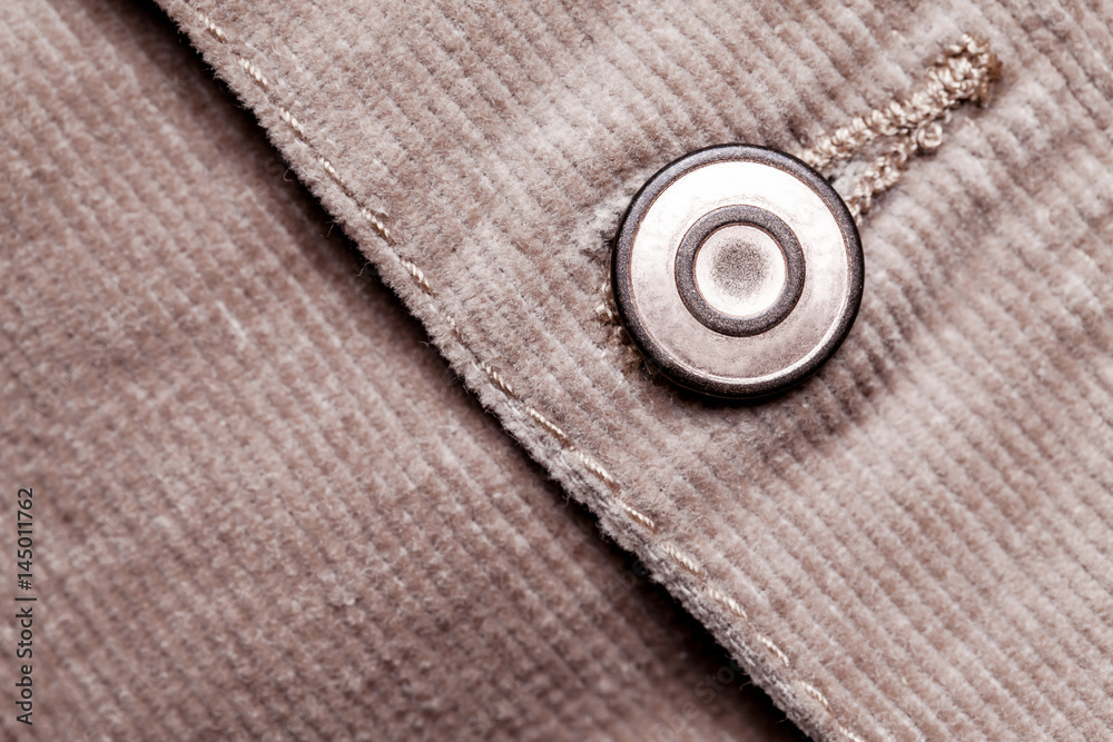 Metal button in corduroy canvas jacket pattern. Metal button in corduroy canvas jacket pattern.