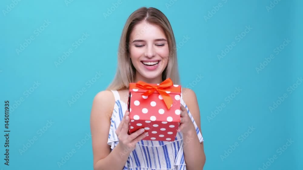 Young smiling woman glad about gift isolated Young smiling woman glad about gift isolated