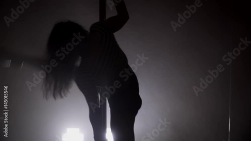 Wallpaper Mural Silhouette of a young woman dancing with the pole with smoke Torontodigital.ca