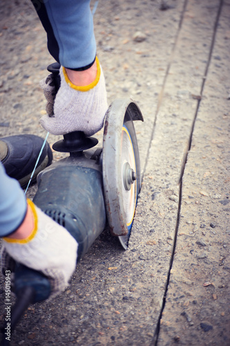 Cutting asphalt with a power tool with a special blade. photo