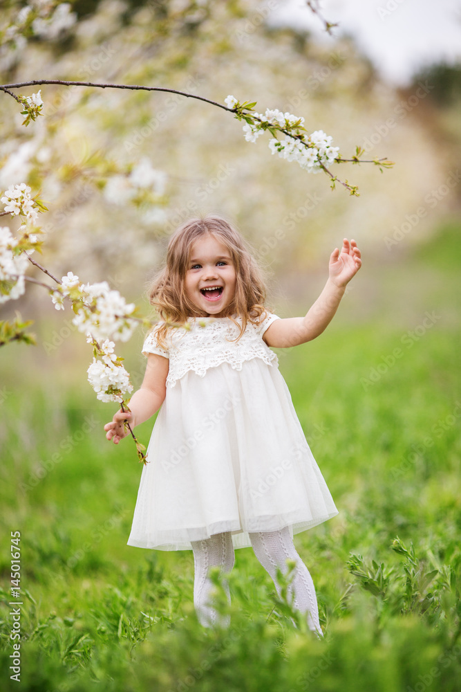 Pretty child girl in blossom spring garden Pretty child girl in blossom spring garden