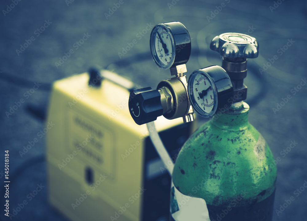 Welding Equipment. Acetylene gas cylinder tank with gauge regulators manometers. - obrazy, fototapety, plakaty 