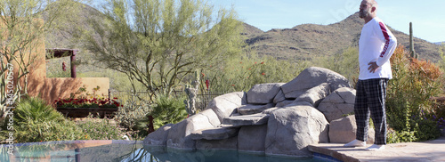 A Man Stands Poolside in Arizona's Sonoran Desert photo