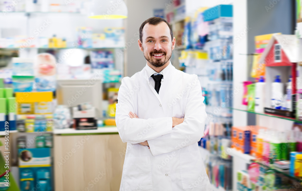 Glad male pharmacist suggesting useful drug
