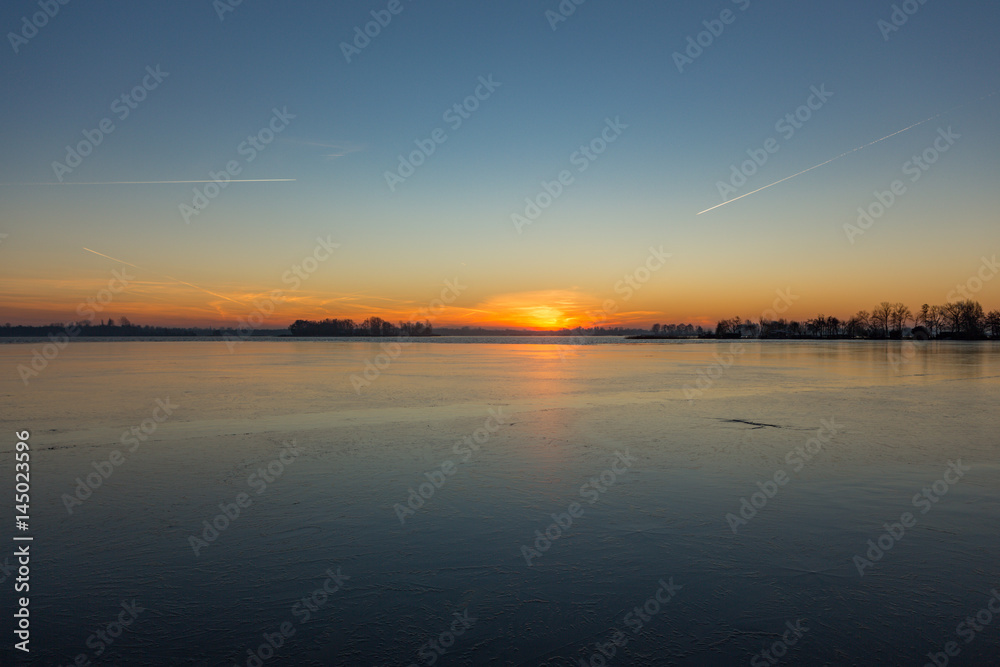 Sunrise over the frozen lakes in Loosdrecht the Netherlands