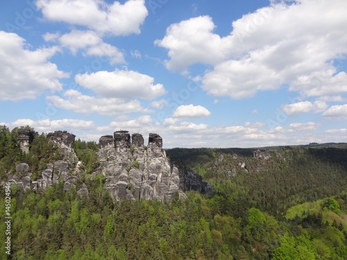The Elbe Sandstone Mountains near the Bastei bridge in the Saxon Switzerland National Park in Germany with blue sky and clouds