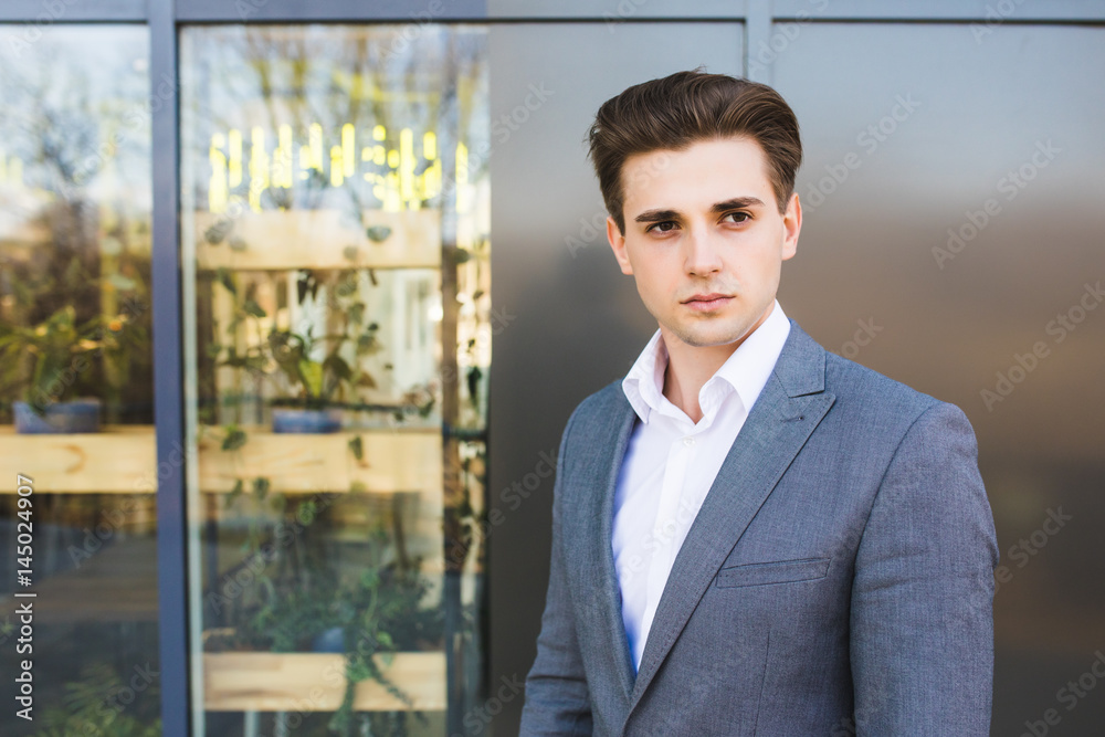 Portrait of an handsome businessman outdoors on office building background Portrait of an handsome businessman outdoors on office building background