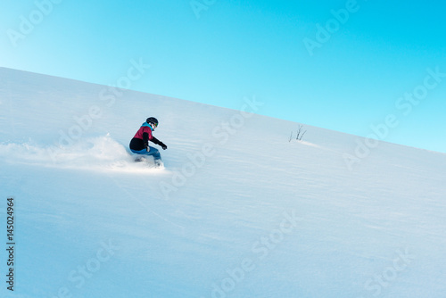 snowboarder is riding from mountain