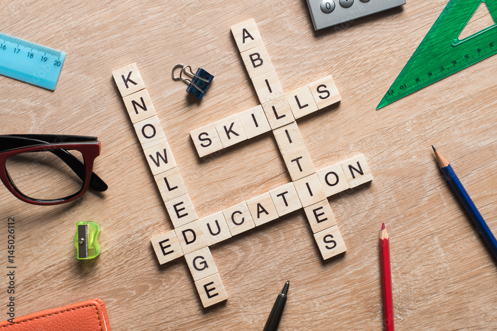 Conceptual keywords on wooden table with elements of game making crossword Conceptual keywords on wooden table with elements of game making crossword