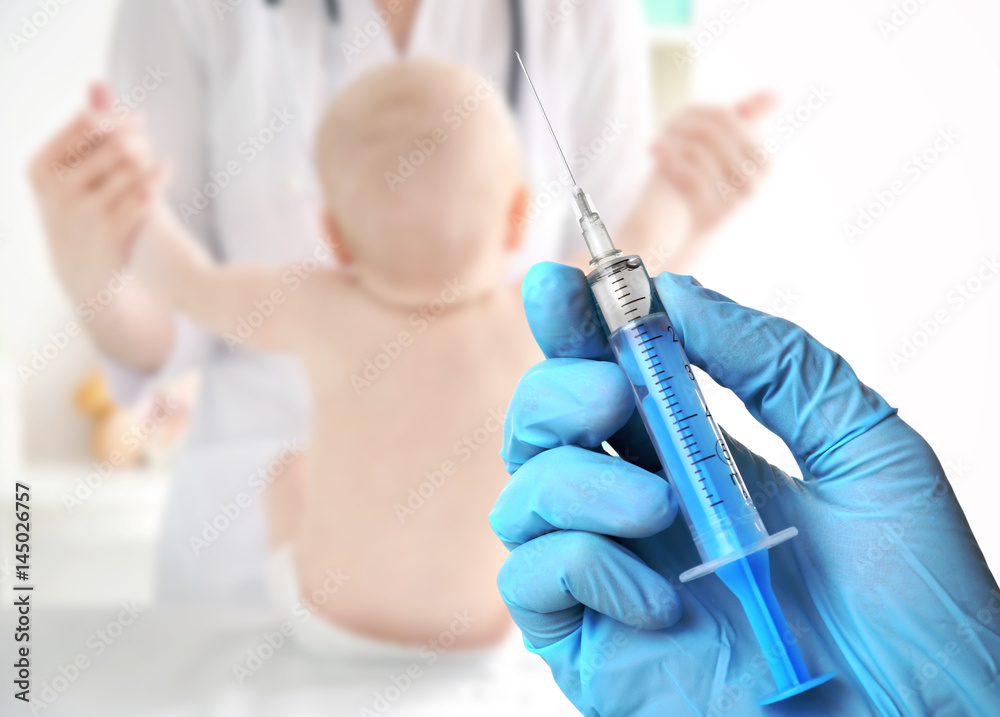 Hand in gloves with syringe isolated on white Hand in gloves with syringe isolated on white