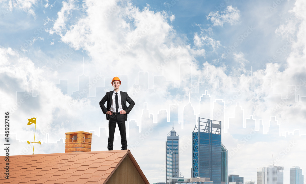 Engineer man standing on roof and looking away. Mixed media Engineer man standing on roof and looking away. Mixed media