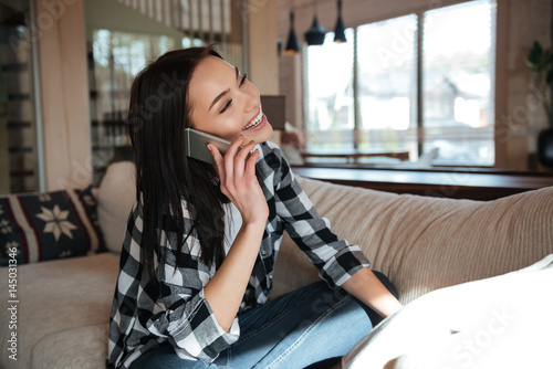 smiling woman talking on phone © Drobot Dean