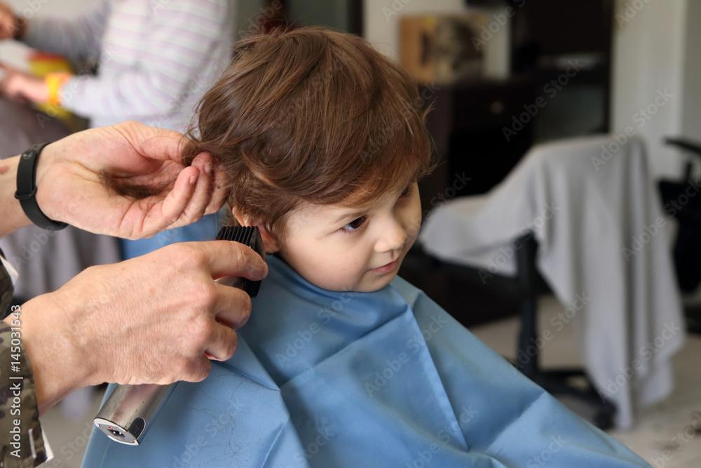 little kid cutting the hair in the barbershop little kid cutting the hair in the barbershop