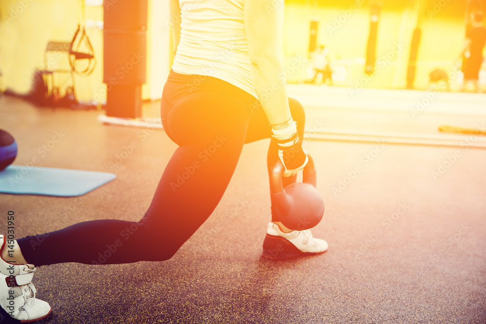 Close-up girl is Training with a dumbbell in the gym.concept of fitness Close-up girl is Training with a dumbbell in the gym.concept of fitness