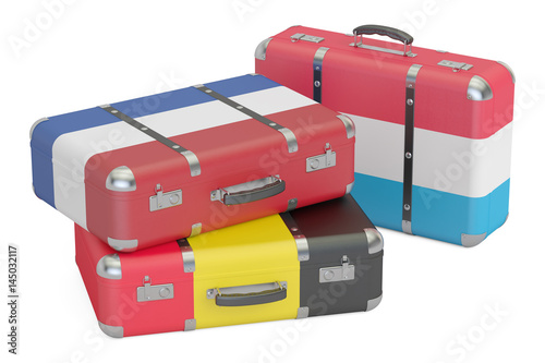 Travel around Europe concept, suitcases with flags of Belgium, Netherlands and Luxembourg. 3D rendering