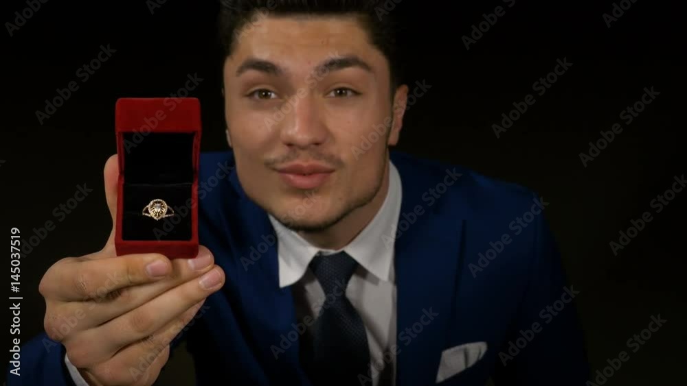 Man kneeling with engagement ring box in hand for marriage proposal Man kneeling with engagement ring box in hand for marriage proposal