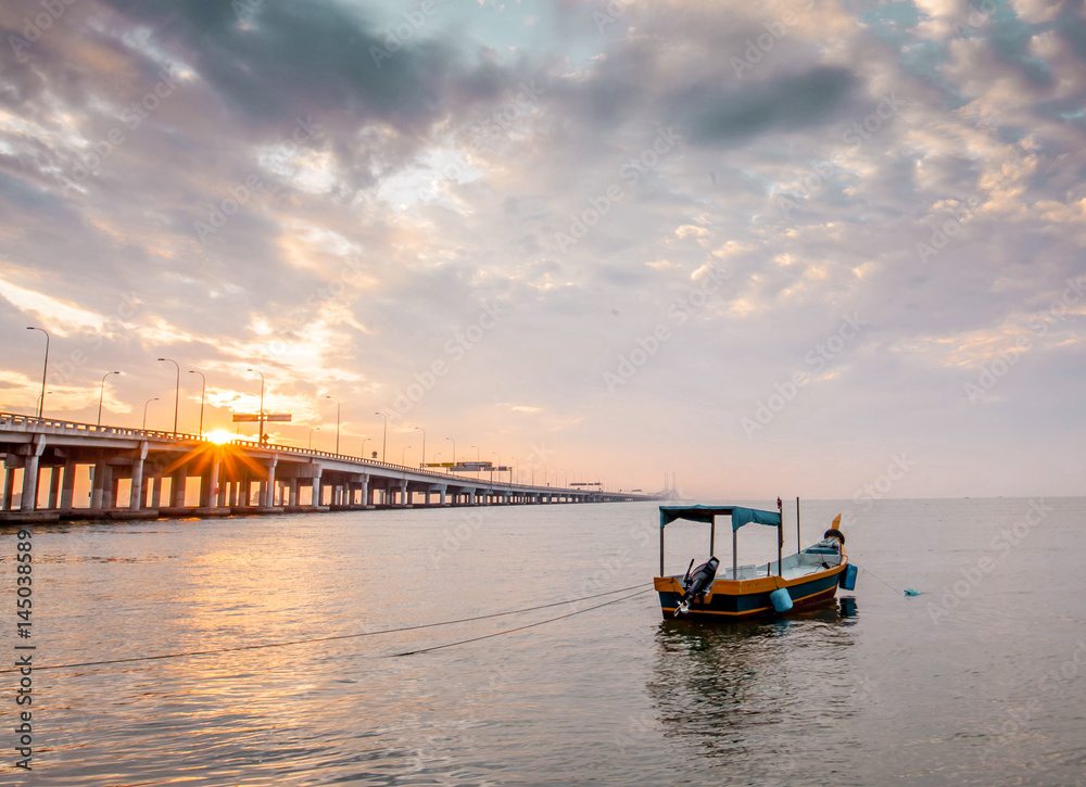 fisherman boat and Penang bridge,Malaysia during sunset