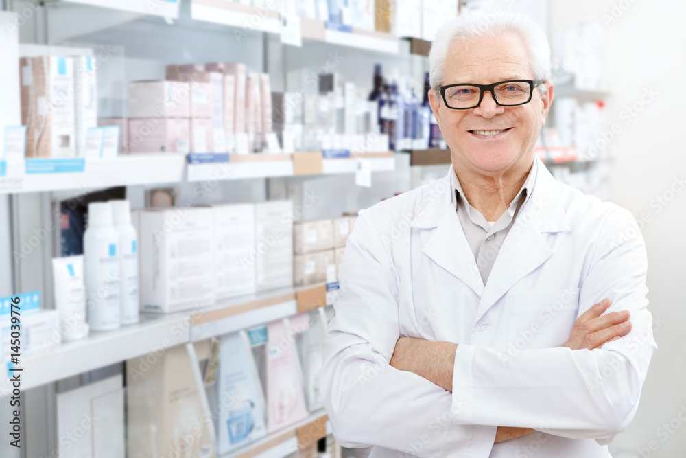 Senior male pharmacist working at his drugstore Senior male pharmacist working at his drugstore