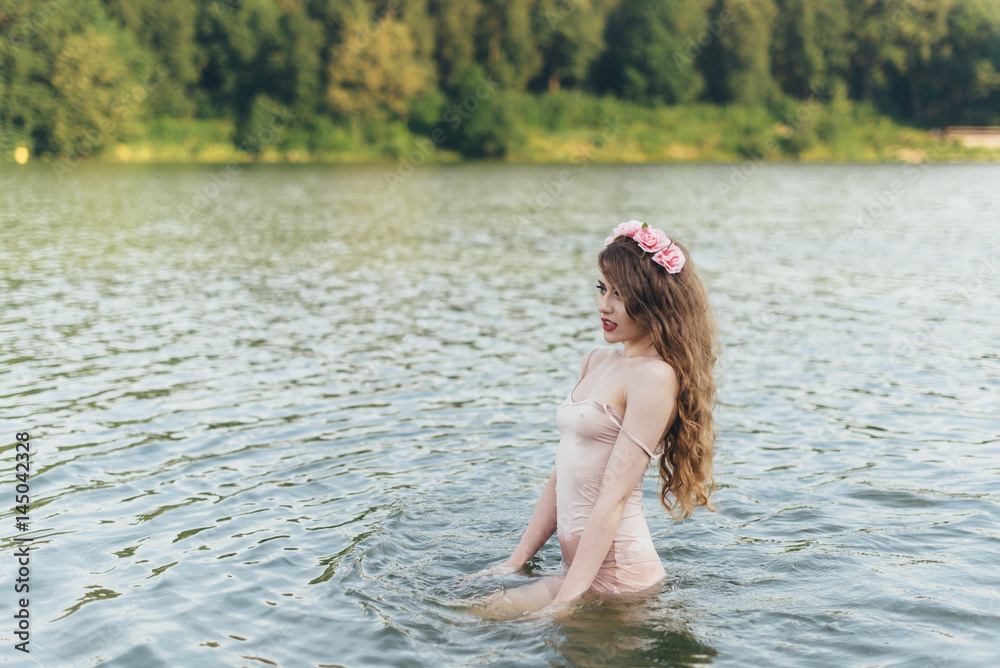Fototapeta premium Girl with a wreath in the water