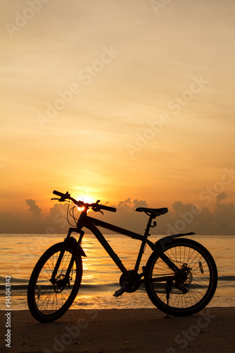 silhouette bicycle on the beach