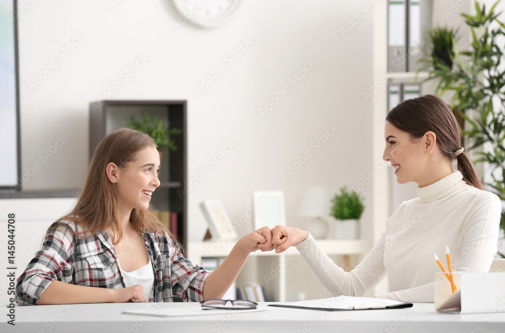 Young female psychologist working with teenager girl in office Young female psychologist working with teenager girl in office