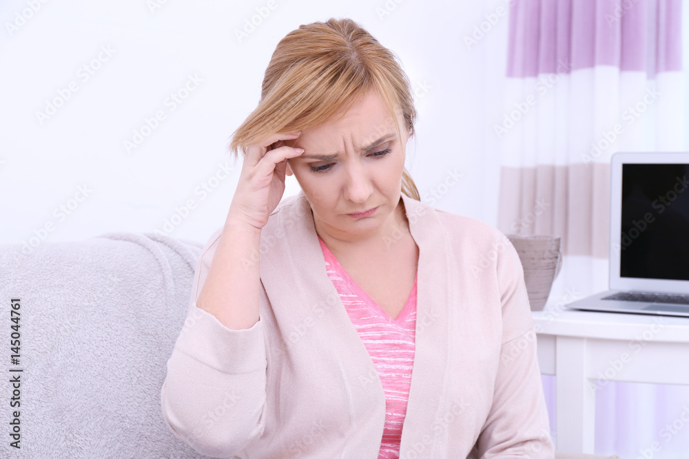 Senior woman suffering from headache at home Senior woman suffering from headache at home