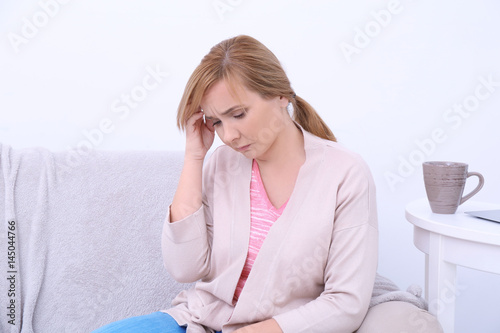 Senior woman suffering from headache at home