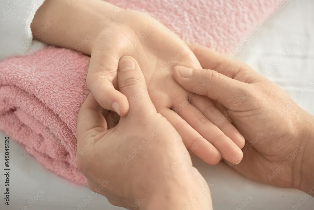Young woman receiving hand massage in spa salon, closeup Young woman receiving hand massage in spa salon, closeup