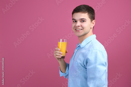 Young man drinking juice on...