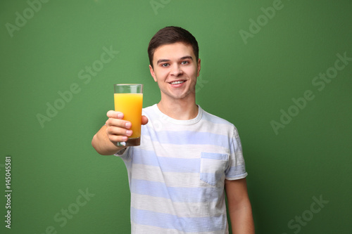 Young man drinking juice on...
