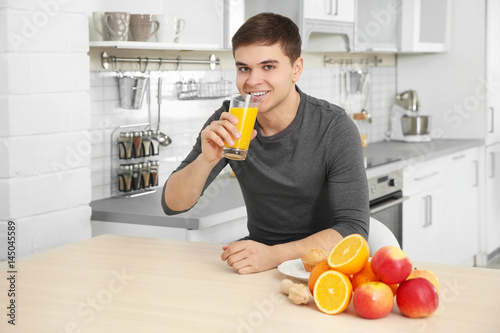 Young man drinking juice on...