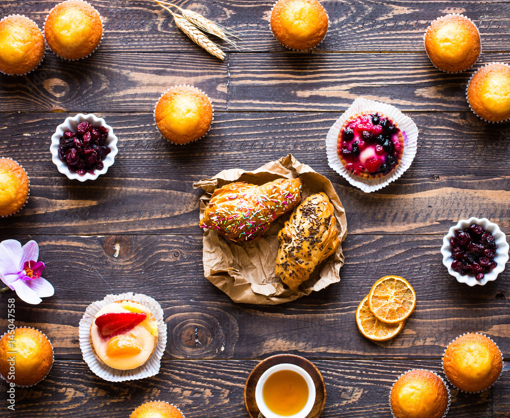 Delicious homemade muffins with yogurt, on a wooden background with space for text. Delicious homemade muffins with yogurt, on a wooden background with space for text.