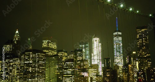 Manhattan skyline as seen on the Brooklyn Bridge at night.