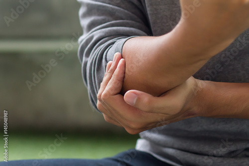 Photography man suffering from joint pain, arthritis, gout, rheumatoid symptoms