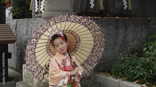 A seven year old girl  dressed up in a Kimono to celebrate the Shichi-Go-San Festival photo