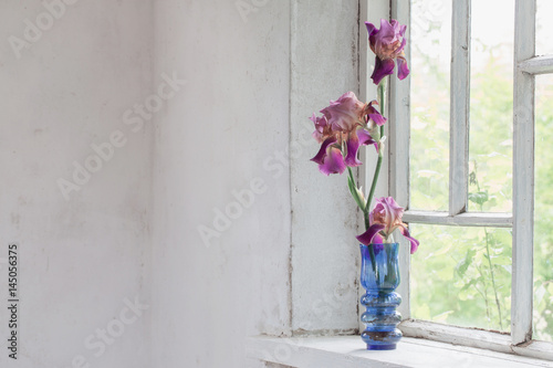 Flower vase sitting inside of window