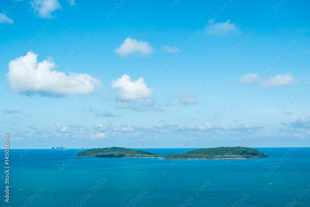 Seascape and small island with blue sky
