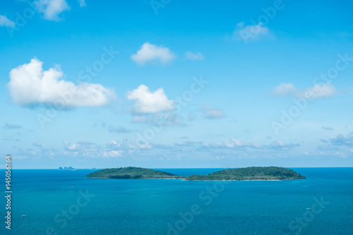 Seascape and small island with blue sky