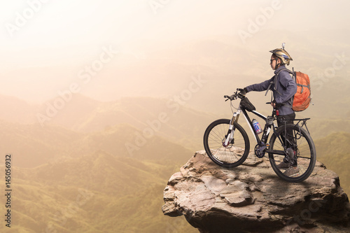 Woman cyclist on the top of the hill