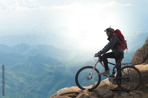 Cyclist on the top of a hill © kromkrathog